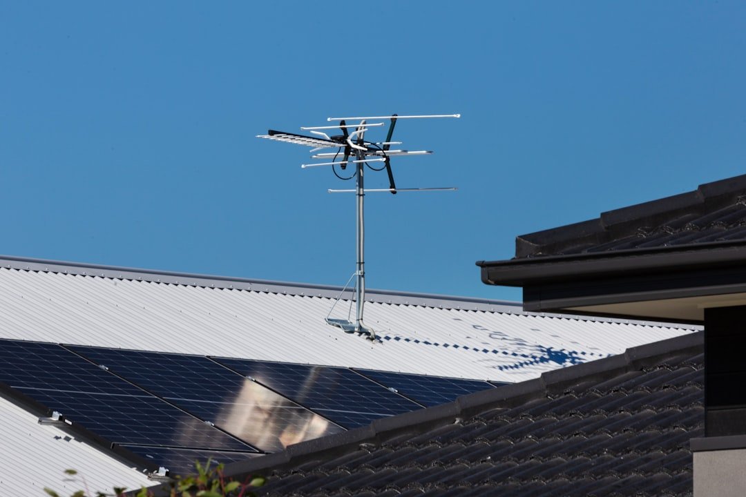 Rooftop solar panels with TV antenna.